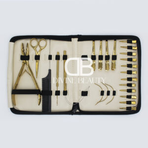 Luxury gold titanium hair extension tool kit featuring extension pliers, sectioning clips, threading needles, loop tools, scissors, comb, and professional salon accessories in a zippered carrying case.