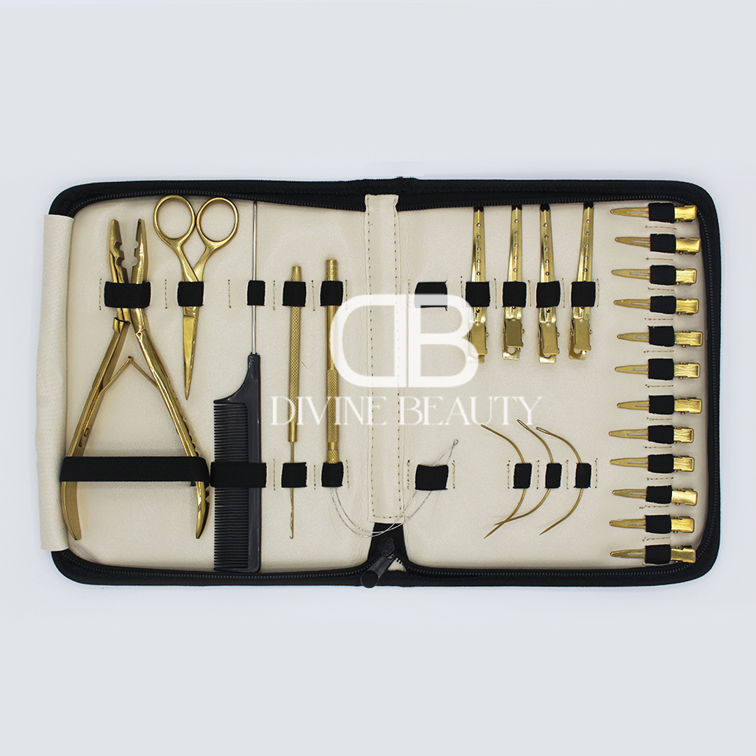 Luxury gold titanium hair extension tool kit featuring extension pliers, sectioning clips, threading needles, loop tools, scissors, comb, and professional salon accessories in a zippered carrying case.